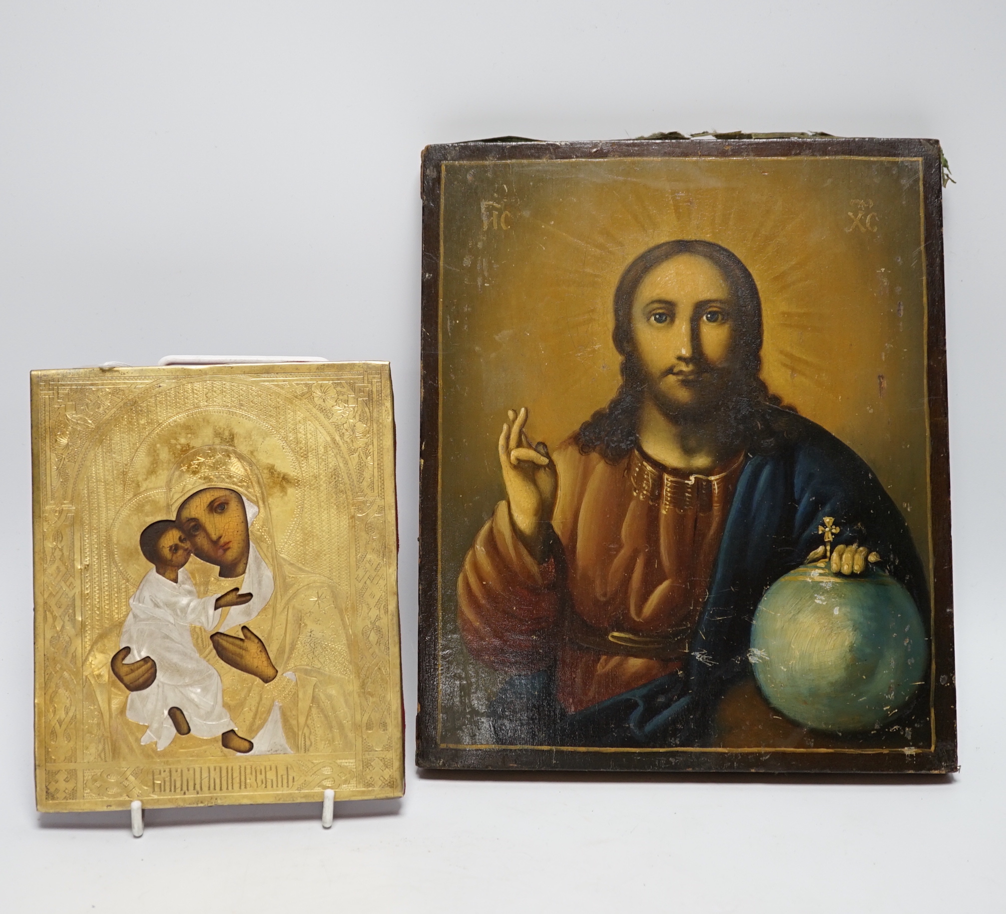 An early 20th century Russian Icon painted on wooden panel of Christ, with inscription and four seals reverse together with a later smaller Icon, largest 22.5cm wide x 27cm high